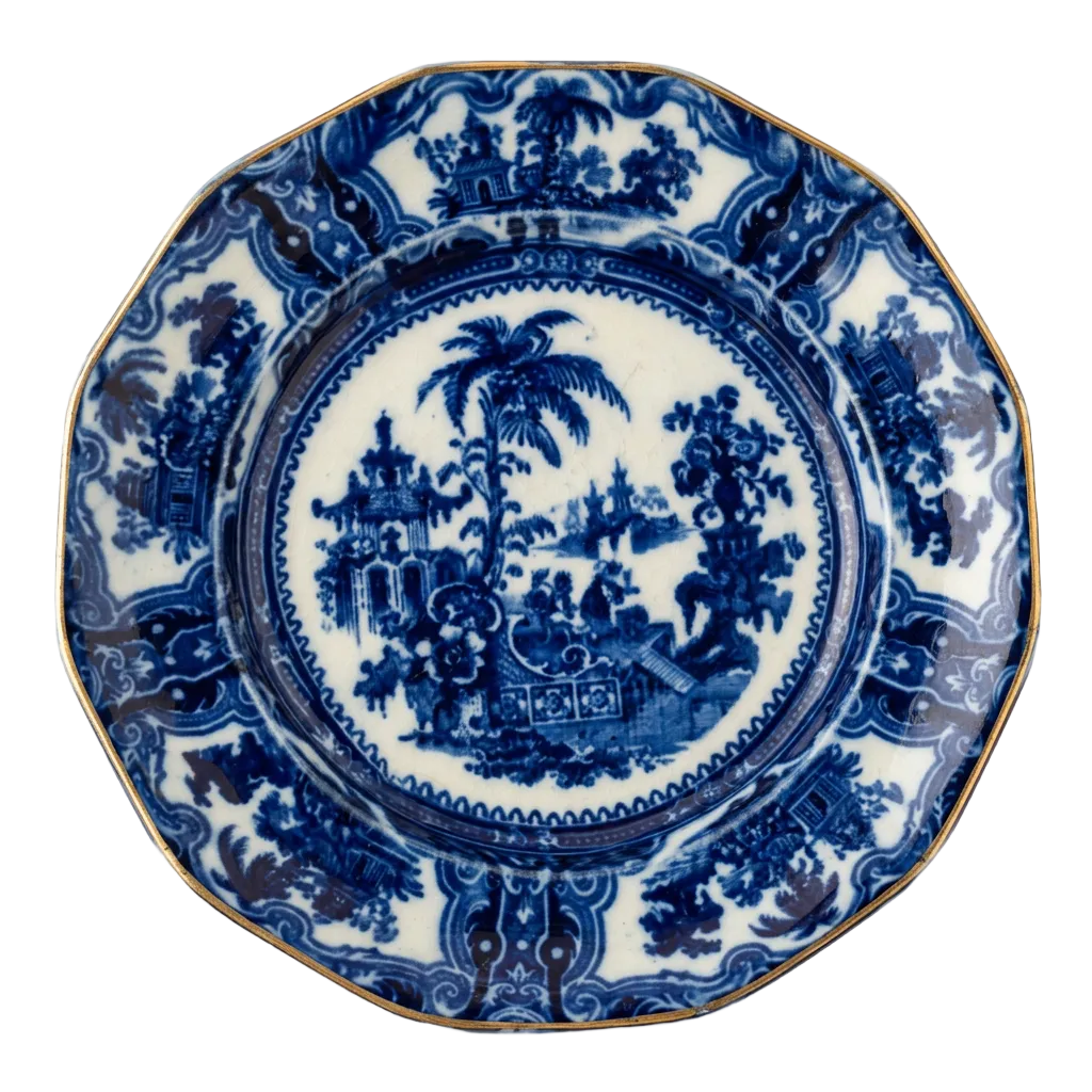 Adams Kyber flow blue dinner plate with gilded rim against an ivory background; one plate shown from the set of two